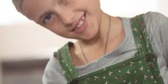 Portrait of smiling girl painting on bowl in pottery workshop